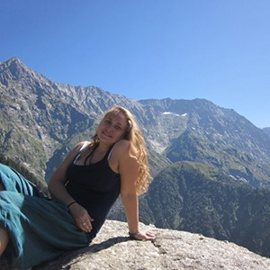 Social worker Neysa Fanwick poses by the mountains in Dharamshala